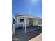 Exterior view of a mobile home with a covered patio and secure enclosure at 3520 N Yucca Dr, Florence, AZ 85132
