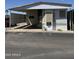Mobile home with a covered parking and desert-friendly landscaping at 3520 N Yucca Dr, Florence, AZ 85132