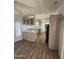 Open-concept kitchen area with light fixtures, countertops, and matching wooden cabinets at 3520 N Yucca Dr, Florence, AZ 85132