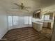 Bright kitchen with stainless steel appliances, light cabinets, and ceiling fan at 3520 N Yucca Dr, Florence, AZ 85132