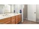 Bathroom with dual sinks, tub, and wood cabinets at 3668 E Cody Ave, Gilbert, AZ 85234