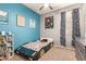 Fun bedroom featuring blue accent walls, playful posters, and a car-shaped bed for creative dreams at 3668 E Cody Ave, Gilbert, AZ 85234