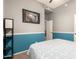 Comfortable bedroom with gray and blue walls, featuring modern art and ample natural light at 3668 E Cody Ave, Gilbert, AZ 85234