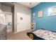 Playful bedroom with blue accent wall, decorative posters, and a car-shaped bed perfect for a  at 3668 E Cody Ave, Gilbert, AZ 85234