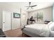 Bedroom with neutral carpet, ceiling fan, and view to gaming room and bathroom at 3668 E Cody Ave, Gilbert, AZ 85234