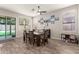 Cozy dining room with wood-look floors, a ceiling fan, and sliding glass doors leading to the backyard at 3668 E Cody Ave, Gilbert, AZ 85234