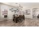 Comfortable dining room with wood-look floors, a ceiling fan, and an open view to the living area at 3668 E Cody Ave, Gilbert, AZ 85234