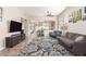 Relaxing living room featuring modern furniture, wood-look floors, and an open flow to the dining area at 3668 E Cody Ave, Gilbert, AZ 85234