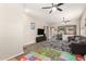 Open-concept living room with wood-look floors, ceiling fans, and a seamless transition to other living spaces at 3668 E Cody Ave, Gilbert, AZ 85234