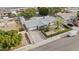 Lovely home with a gray roof, green landscaping, and an extended driveway at 3802 W Rue De Lamour Ave, Phoenix, AZ 85029