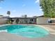 Backyard boasts sparkling pool and outdoor dining, surrounded by mature landscaping and desert scenery at 3802 W Rue De Lamour Ave, Phoenix, AZ 85029