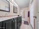 Double sink bathroom with marble counters, modern lights and bathtub with shower, with plenty of space at 3802 W Rue De Lamour Ave, Phoenix, AZ 85029
