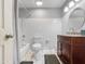 Well-lit bathroom featuring white tile and modern fixtures, including a vanity and a shower and bathtub at 3802 W Rue De Lamour Ave, Phoenix, AZ 85029
