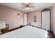 Relaxing bedroom with ceiling fan, hardwood floors, and natural light from large window at 3802 W Rue De Lamour Ave, Phoenix, AZ 85029