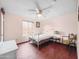 Cozy bedroom features ceiling fan, window and light-colored walls with a light-colored floor at 3802 W Rue De Lamour Ave, Phoenix, AZ 85029