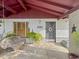 Cozy front porch features a hanging swing and view of the house entrance with desert landscaping at 3802 W Rue De Lamour Ave, Phoenix, AZ 85029