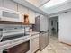 Kitchen with stainless steel fridge and white appliances at 3802 W Rue De Lamour Ave, Phoenix, AZ 85029