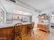 Eat-in kitchen featuring a breakfast bar with two barstools at 3802 W Rue De Lamour Ave, Phoenix, AZ 85029