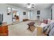Cozy living room with beige carpet, ceiling fan, and staircase detail at 3802 W Rue De Lamour Ave, Phoenix, AZ 85029