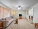 Bright living room with ceiling fan, couch, and neutral carpet at 3802 W Rue De Lamour Ave, Phoenix, AZ 85029