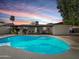 Inviting pool area surrounded by a patio perfect for outdoor entertaining, with colorful sunset views at 3802 W Rue De Lamour Ave, Phoenix, AZ 85029