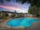 Backyard pool with patio, perfect for relaxation and outdoor gatherings under the beautiful blue sky at 3802 W Rue De Lamour Ave, Phoenix, AZ 85029