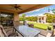 Covered patio overlooking a landscaped backyard with artificial turf, a gazebo, a barbecue, and a fire pit at 38397 N Nuevo Laredo Ln, San Tan Valley, AZ 85140