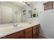 Bathroom featuring a double sink vanity, a large mirror, and neutral wall paint at 38397 N Nuevo Laredo Ln, San Tan Valley, AZ 85140