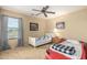 Bedroom with two beds, a ceiling fan, and a window with checkered drapes at 38397 N Nuevo Laredo Ln, San Tan Valley, AZ 85140