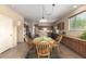 Open dining room featuring wood table, chairs and views into kitchen area at 38397 N Nuevo Laredo Ln, San Tan Valley, AZ 85140