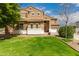 Beautiful two-story home with lush green lawn, mature trees, and a three-car garage at 38397 N Nuevo Laredo Ln, San Tan Valley, AZ 85140