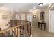 Hallway on second floor, with decorative wrought iron, and open view to doorways and wall art at 38397 N Nuevo Laredo Ln, San Tan Valley, AZ 85140