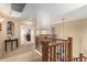 Open hallway on second floor with decorative wrought iron and view to downstairs at 38397 N Nuevo Laredo Ln, San Tan Valley, AZ 85140
