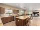 Kitchen with an island that seats four opens to a dining and living room area, perfect for entertaining at 38397 N Nuevo Laredo Ln, San Tan Valley, AZ 85140