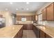 Spacious kitchen has stainless steel appliances, an island, and tile floors, ready for cooking and entertaining at 38397 N Nuevo Laredo Ln, San Tan Valley, AZ 85140