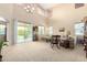 Bright living room with soaring ceilings, a sliding glass door, and neutral decor at 38397 N Nuevo Laredo Ln, San Tan Valley, AZ 85140