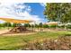 Community park and playground with shade structures, a jungle gym, and a swing set at 38397 N Nuevo Laredo Ln, San Tan Valley, AZ 85140