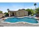 Backyard with a beautiful pool, desert landscaping, covered patio, and lounge chairs at 384 N Scott Dr, Chandler, AZ 85225