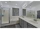 A luxurious bathroom with double sinks, shower, tub, and a large mirror at 384 N Scott Dr, Chandler, AZ 85225