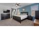 This bedroom features a ceiling fan, carpet, and a dark wood bedframe that matches the dresser at 384 N Scott Dr, Chandler, AZ 85225