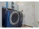 Modern laundry room with front loading washer and dryer and extra storage at 384 N Scott Dr, Chandler, AZ 85225