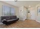 Cozy living room featuring wood floors, neutral paint, and a black futon at 384 N Scott Dr, Chandler, AZ 85225