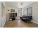Cozy living room featuring wood floors, neutral paint, and a black futon at 384 N Scott Dr, Chandler, AZ 85225