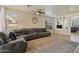 Bright living room with large windows, neutral walls, ceiling fan, and a comfortable, oversized sectional couch at 384 N Scott Dr, Chandler, AZ 85225