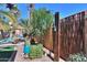 Resort-style backyard with a pool, outdoor shower, comfortable seating, and tropical landscaping at 45176 W Alamendras St, Maricopa, AZ 85139