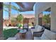 Private backyard setting with comfortable lounge seating, mature plants, and ample shade for enjoying the outdoors at 45176 W Alamendras St, Maricopa, AZ 85139