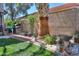 Serene backyard featuring lush landscaping, a barbecue grill, and elegant statue accents at 45176 W Alamendras St, Maricopa, AZ 85139