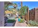 Serene backyard with a pool, hammock, and outdoor shower, surrounded by mature plants and desert landscaping at 45176 W Alamendras St, Maricopa, AZ 85139