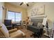 Charming bedroom with desk, armchair, and gray bed with silver headboard for a creative, relaxing space at 45176 W Alamendras St, Maricopa, AZ 85139