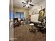 Bedroom featuring neutral tones, carpeted floors, a ceiling fan, and creative artwork, creating an inviting and relaxing space at 45176 W Alamendras St, Maricopa, AZ 85139